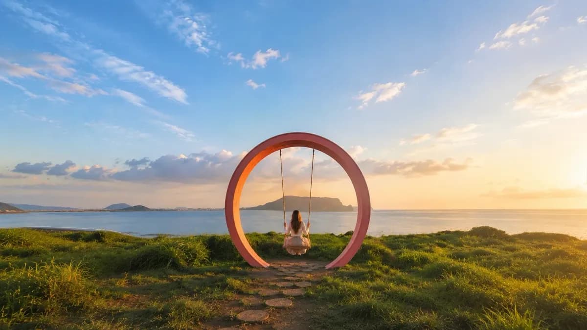 Woman on a circular swing facing the ocean and Seongsan Ilchulbong, Seopjikoji, Jeju
